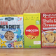 Five brands of vegan boxed mac and cheese on a countertop